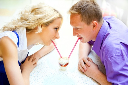 Closeup portrait of young cute couple at mall cafe. の写真素材