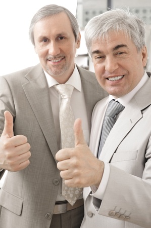 Portrait of two businessmen who approve. Office background.の写真素材