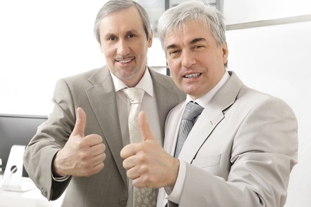 Portrait of two businessmen who approve. Office background.の写真素材