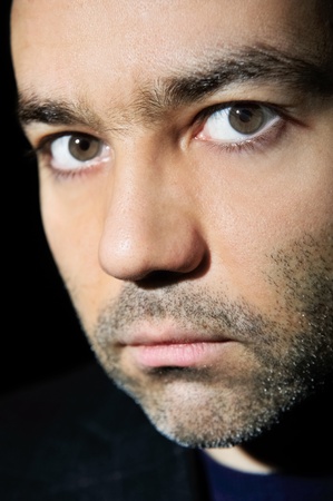 Closeup image of a happy aged man against dark background