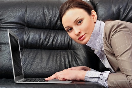 Portrait of a beautiful young woman working on laptop の写真素材