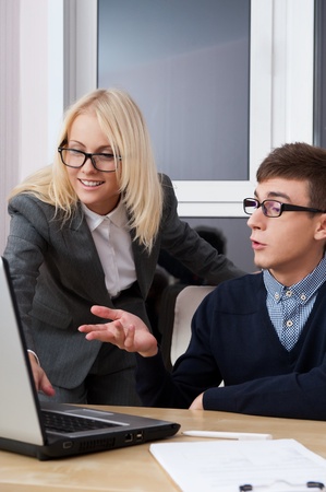 Young successful smiling business people are working in the office.の写真素材