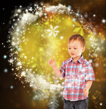 Little boy conjuring with his handsの写真素材