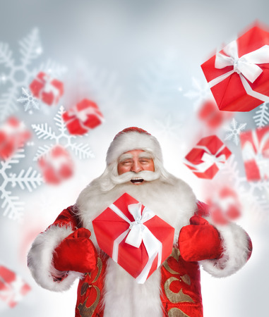 Laughing Santa Claus standing and doing magic. Gift boxes falling down around himの写真素材