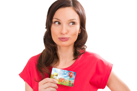 Young pretty woman holding plastic bank card and planning her spendingの写真素材