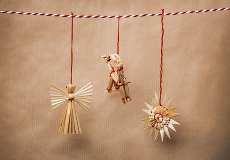 Handmade traditional christmas decoration angel, goat and snowflake from strawの写真素材