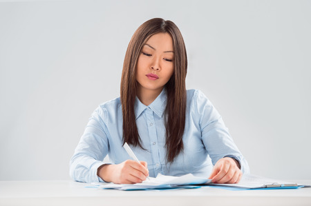 View of pretty business woman focusing on business planの写真素材
