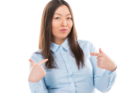 Portrait of attractive asian business woman making choose me sign isolated on white backgroundの写真素材