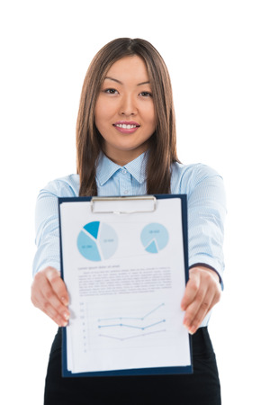 Asian business woman holding reports and smiling. Copy spaceの写真素材