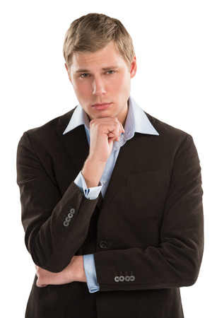 A thoughtful young executive gazing curiously at copyspace while isolated on whiteの写真素材