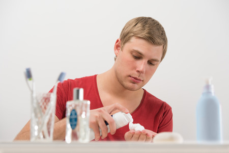 Young man shaving at homeの写真素材