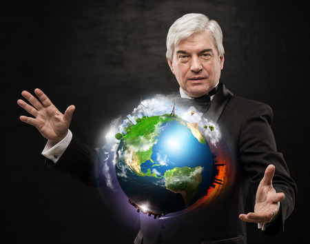 Global Business - A businessman holding worldの写真素材