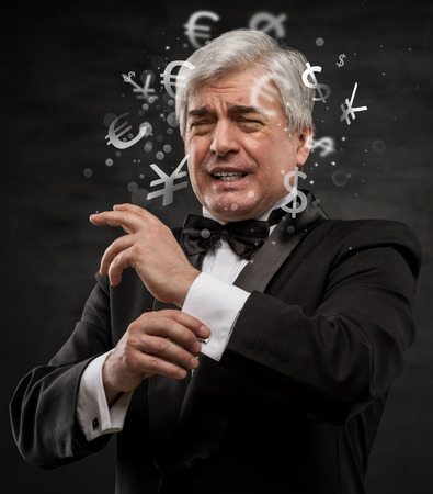 Bad Investment concept. Sad business man with currency symbols.の写真素材