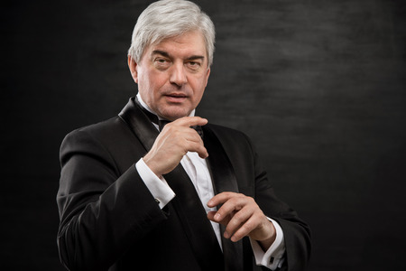 Portrait of professional hypnotist on black backgroundの写真素材