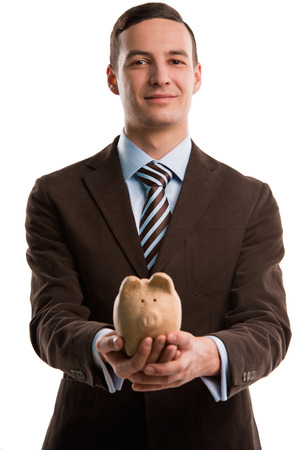Young happy business man holding piggybank over white backgroundの写真素材