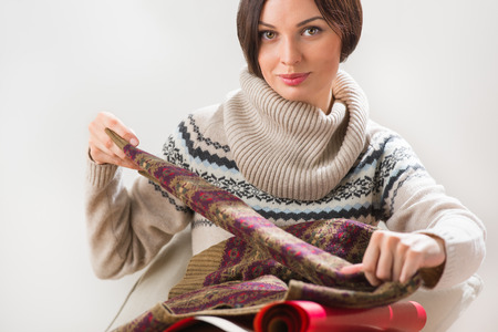 Portrait of a woman preparing to her husband or boyfriend surprise with a gift on his birthday or christmas or valentine's day or another holidayの写真素材
