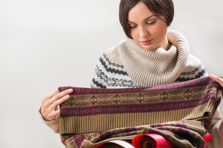 Portrait of a woman preparing to her husband or boyfriend surprise with a gift on his birthday or christmas or valentine's day or another holidayの写真素材