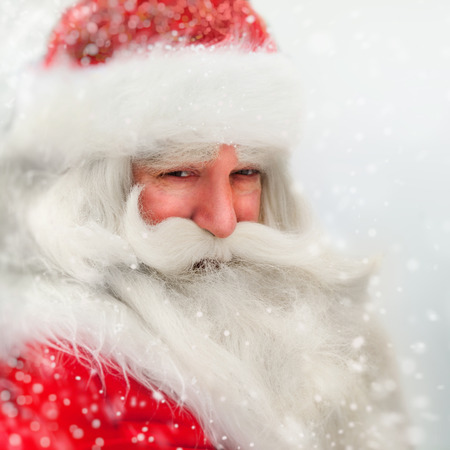 Santa Claus portrait smiling in snowfallの写真素材