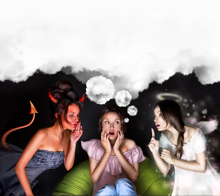 Woman must choose between the devil or angelの写真素材