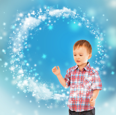 Little boy conjuring with his handsの写真素材