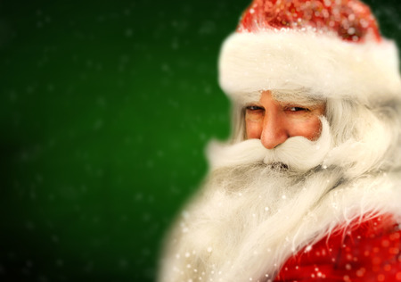 Santa Claus portrait smiling in snowfallの写真素材