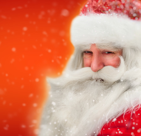 Santa Claus portrait smiling in snowfallの写真素材