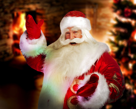 Santa Claus at home at night making magic の写真素材