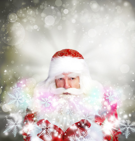 Christmas theme: Santa Claus blowing snowflakes from his arms. Designed Posterの写真素材