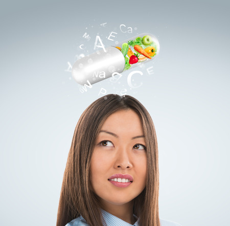Healthy life concept. Woman with vitamins overheadの写真素材