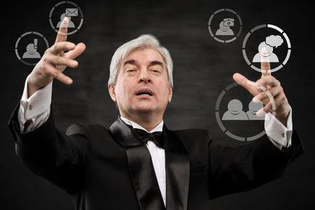 Mature business man pressing social media iconの写真素材
