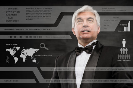 Businessman in black suit working with digital vurtual screenの写真素材
