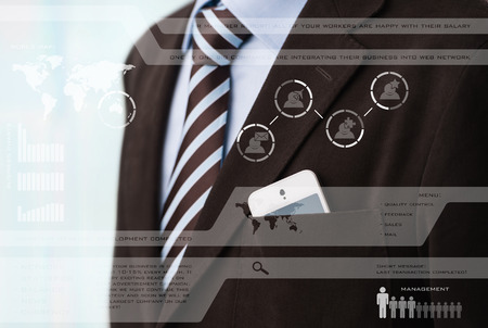Businessman in luxury suit in front of digital vurtual screenの写真素材