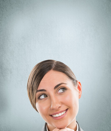 Portrait of happy Caucasian business woman standing over grunge backgroundの写真素材