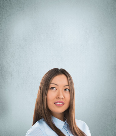 Portrait of happy Caucasian business woman standing over grunge backgroundの写真素材