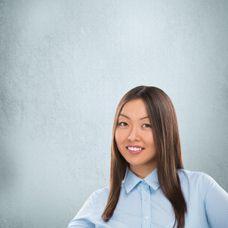 Portrait of happy Caucasian business woman standing over grunge backgroundの写真素材