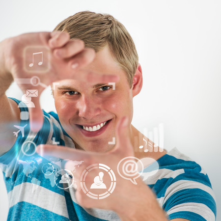Social media concept. Young handsome man using virtual interface with lots of web and social media iconsの写真素材