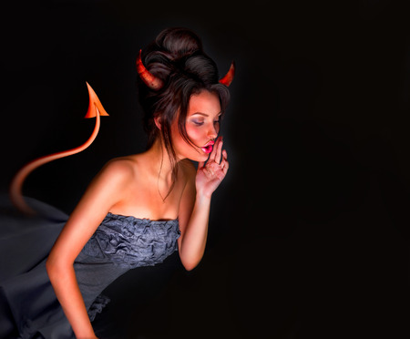 Sexy Devil woman with tail horns and red skin whispering something. Lots of copyspace