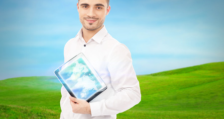 Man using his tablet computer outdoors at countryside. Mobile technology conceptの写真素材
