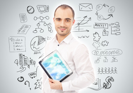 Adult man planning and working using his tablet computerの写真素材
