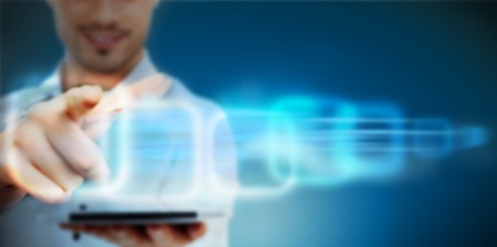Man working with virtual interface on blue digital backgroundの写真素材