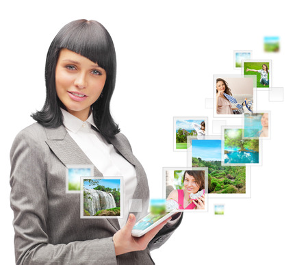 Portrait of young happy woman sharing his photo and video files in social media resources. Isolated on White backgroundの写真素材