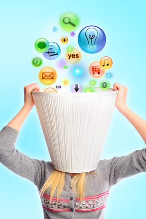 Young woman with lampshade on her head and icons falling inside. Lots of daily tasks conceptの写真素材