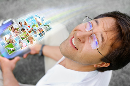 Man holding tablet computer and using social media. Always stay in touch conceptの写真素材