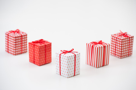 Gift boxes with xmas presents wrapped in red paper with ornament on white background