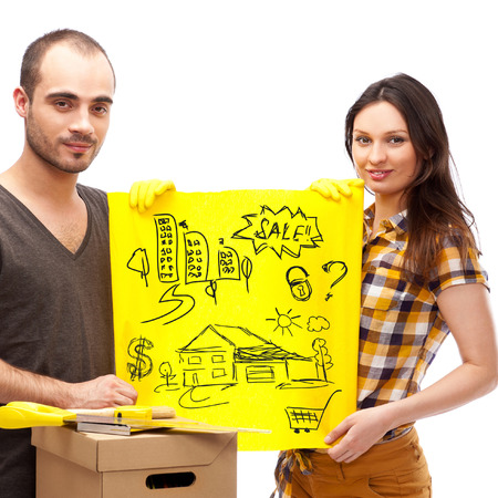 Closeup portrait of adult couple standing on floor at their apartment and planning renovation of their new apartment while resting during houseworkの写真素材