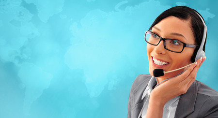 Telemarketing headset woman from call center smiling happy talking in hands free headset device. Business woman in suit in front of world map background.の写真素材