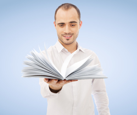 Adult man holding an opened book and reading. Self education of business school conceptの写真素材