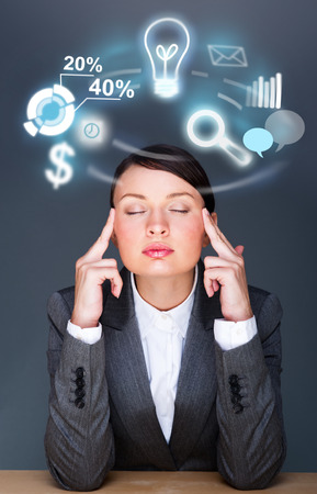 A business woman thinking about her work and tasks and plans. Icons of different actions are flying around her headの写真素材