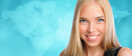 Young beautiful woman standing against worldmap background. International education, business or transportation conceptの写真素材