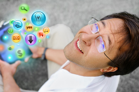 Adult man using his tablet computer to do his tasks everywhereの写真素材